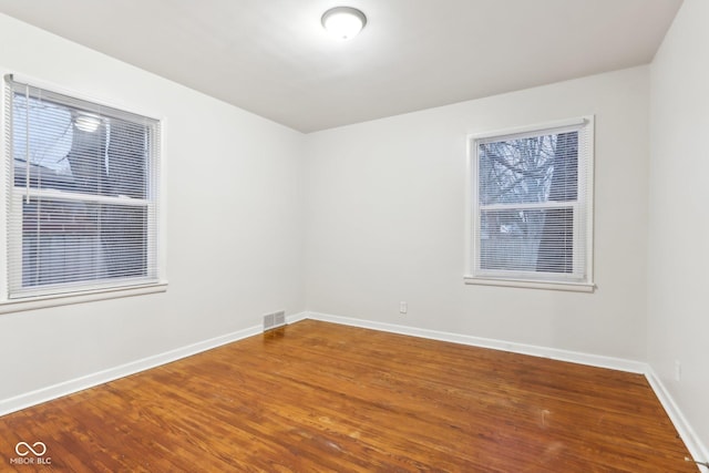 empty room with hardwood / wood-style floors