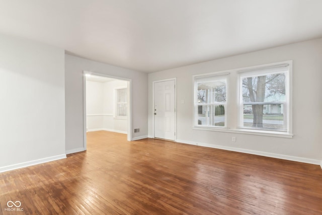 spare room with hardwood / wood-style floors