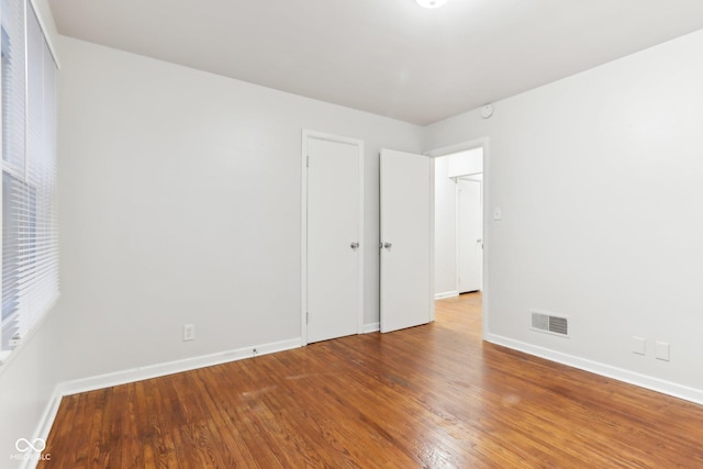 empty room with hardwood / wood-style flooring