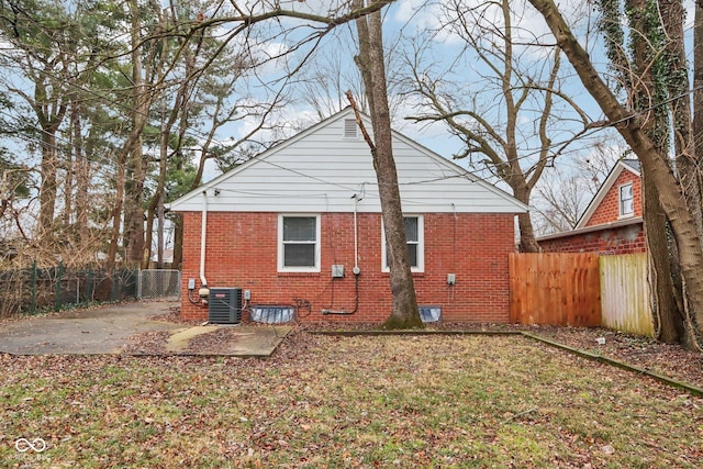 back of house with a patio area, cooling unit, and a yard