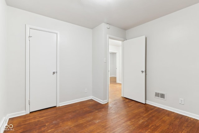 unfurnished bedroom featuring dark hardwood / wood-style floors