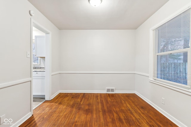 empty room with dark wood-type flooring