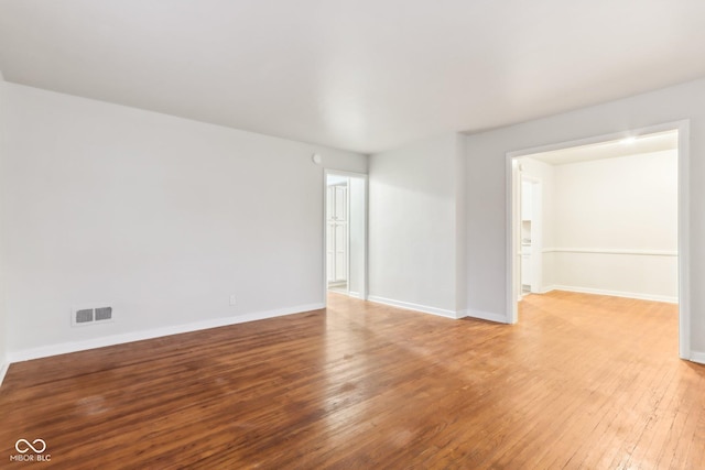 empty room with light hardwood / wood-style flooring