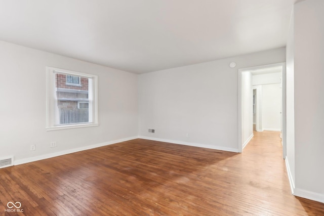 empty room with hardwood / wood-style flooring