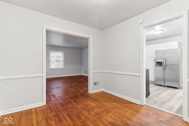 spare room featuring wood-type flooring