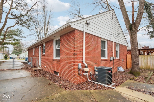 view of property exterior featuring cooling unit and a patio