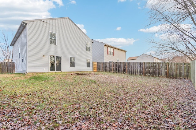 back of house with a yard