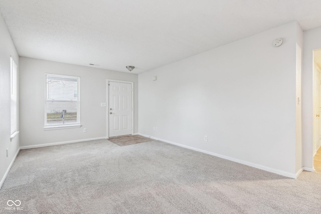 spare room with light colored carpet