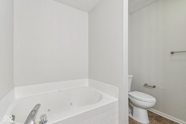 bathroom featuring toilet, a textured ceiling, and tiled tub