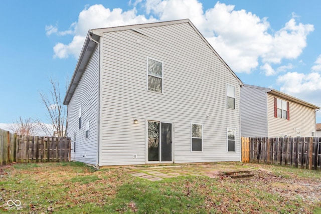 back of house with a lawn