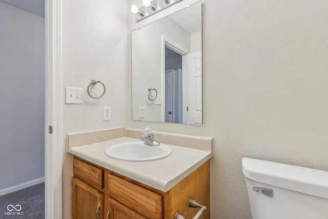 bathroom featuring toilet and vanity