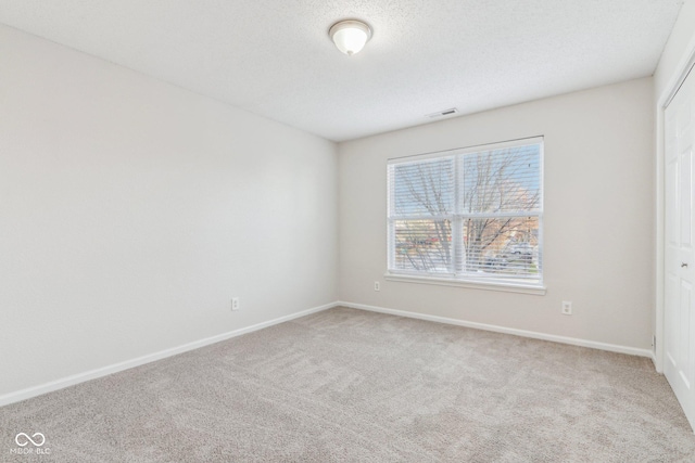 spare room featuring carpet