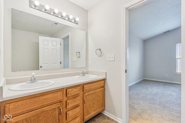 bathroom featuring a textured ceiling and vanity