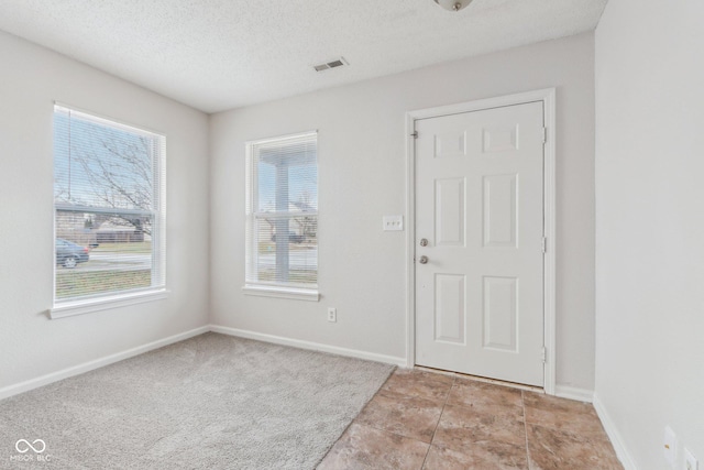 foyer with a textured ceiling