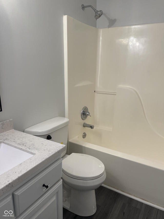 full bathroom with vanity, toilet, wood-type flooring, and tub / shower combination