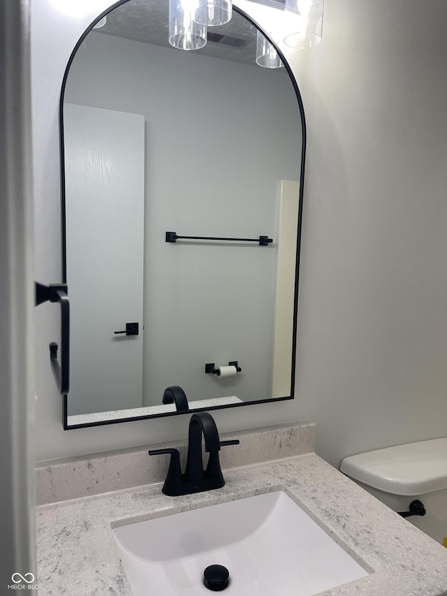 bathroom with vanity and toilet