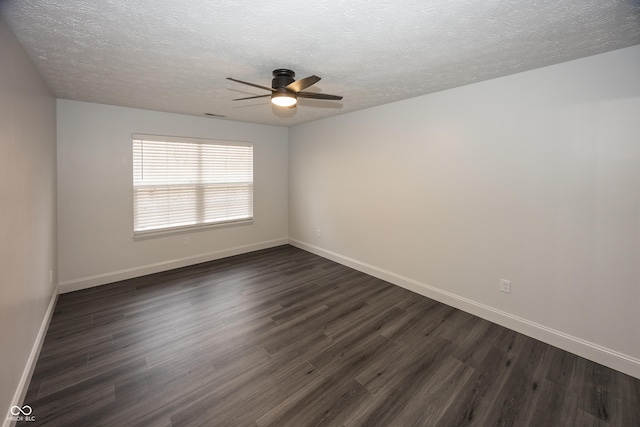 unfurnished room featuring ceiling fan, dark wood-type flooring, and a textured ceiling