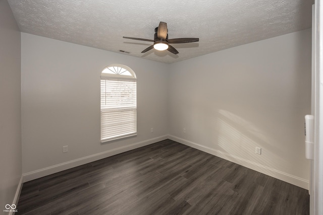 empty room featuring dark hardwood / wood-style flooring, a textured ceiling, and ceiling fan