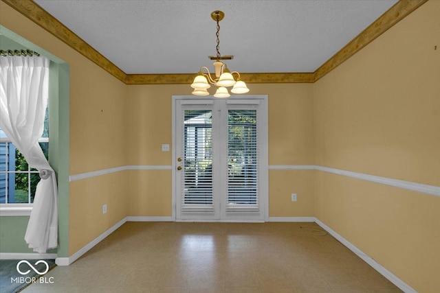 unfurnished room with a textured ceiling and a notable chandelier