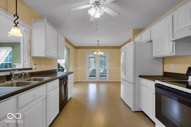 kitchen featuring white cabinets, electric range, hanging light fixtures, and sink