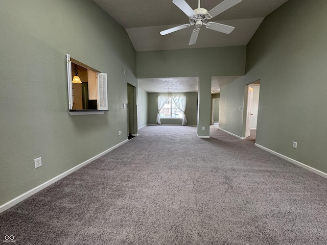 unfurnished living room with carpet floors, vaulted ceiling, and ceiling fan