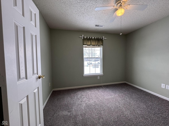 spare room featuring carpet flooring, a textured ceiling, and ceiling fan