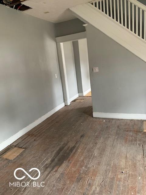 unfurnished room featuring dark wood-type flooring