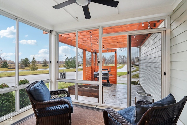 sunroom / solarium featuring ceiling fan and plenty of natural light