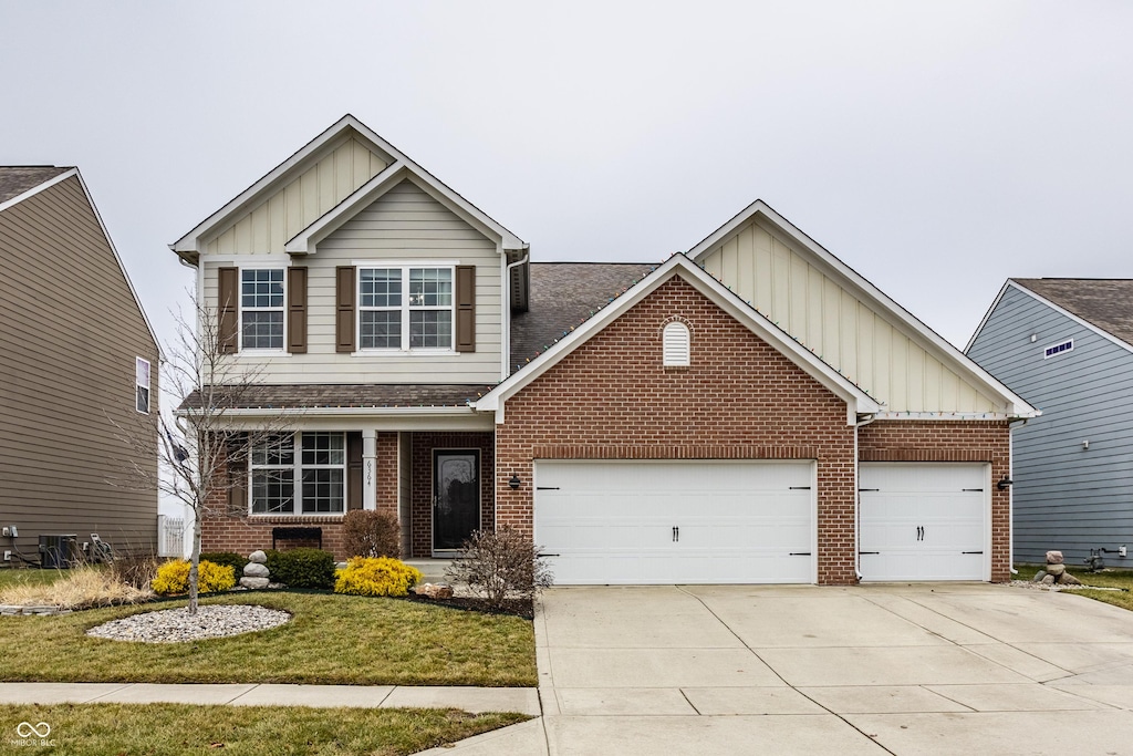 craftsman-style home featuring a garage and a front lawn