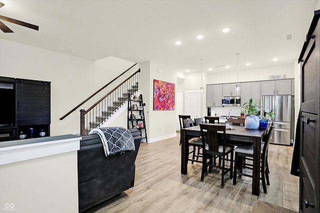 dining room featuring light hardwood / wood-style flooring and ceiling fan