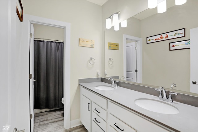 bathroom featuring hardwood / wood-style floors, vanity, and toilet