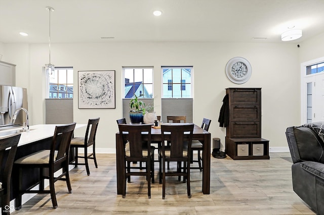 dining space featuring sink and light hardwood / wood-style floors