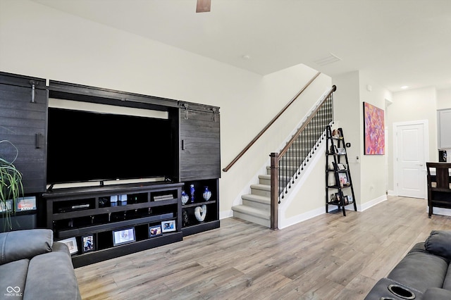 living room featuring light hardwood / wood-style floors and a barn door