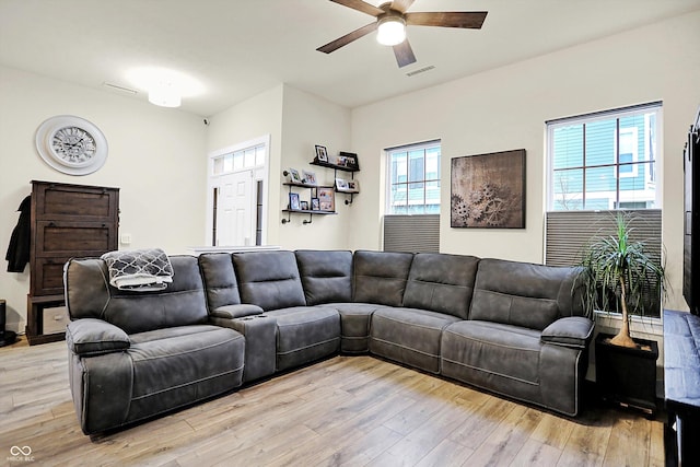 living room with ceiling fan and light hardwood / wood-style floors