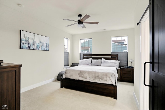 bedroom with ceiling fan and light colored carpet