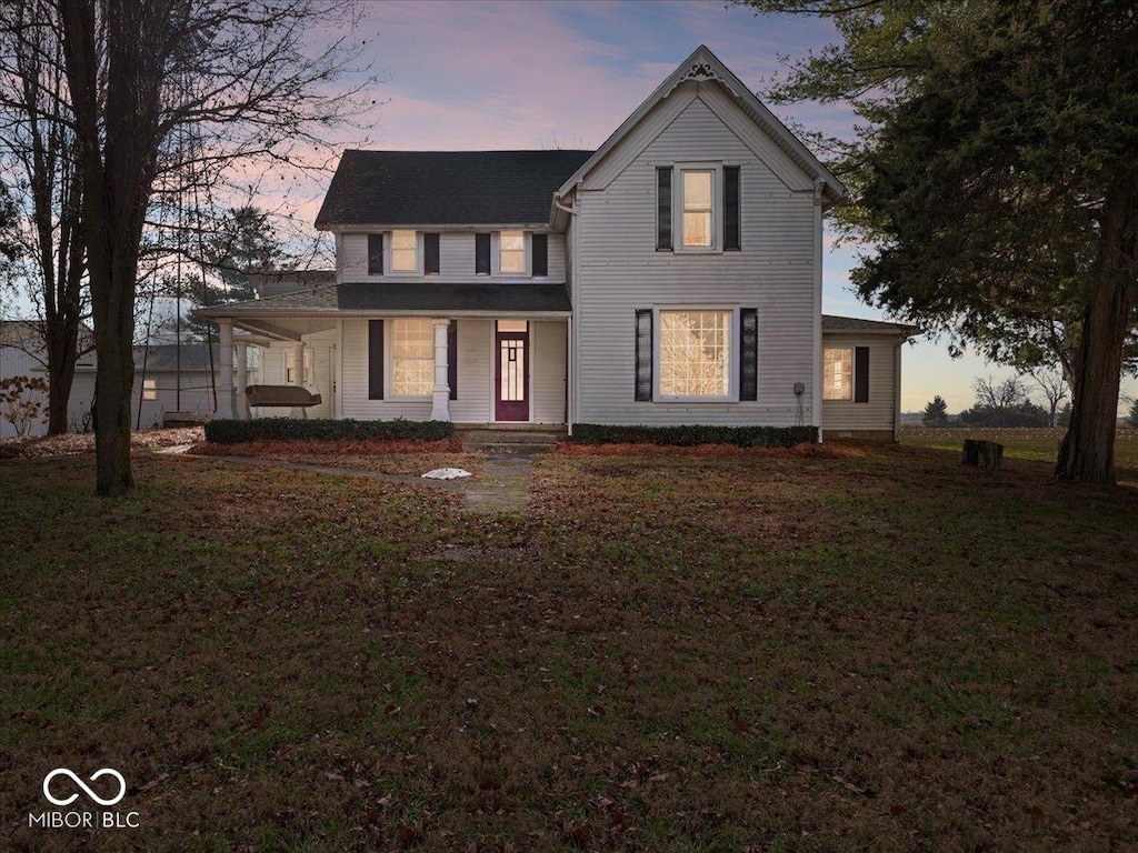 view of front of property featuring a lawn and covered porch