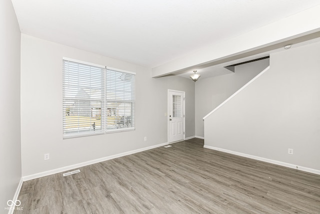 6927 Park Grove Blvd, Whitestown, IN 46075 - unfurnished living room with wood finished floors and stairs