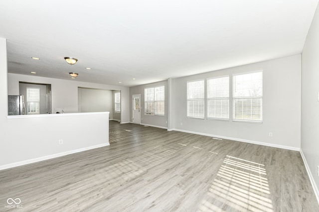 unfurnished living room with light wood-type flooring