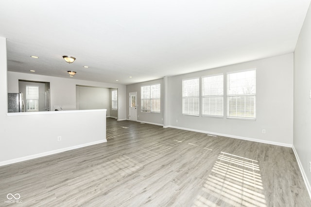 6927 Park Grove Blvd, Whitestown, IN 46075 - unfurnished living room featuring wood finished floors and recessed lighting