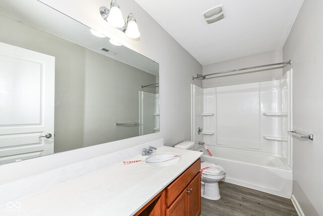 full bathroom with vanity, washtub / shower combination, wood-type flooring, and toilet