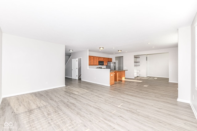 6927 Park Grove Blvd, Whitestown, IN 46075 - unfurnished living room with light wood-type flooring and recessed lighting