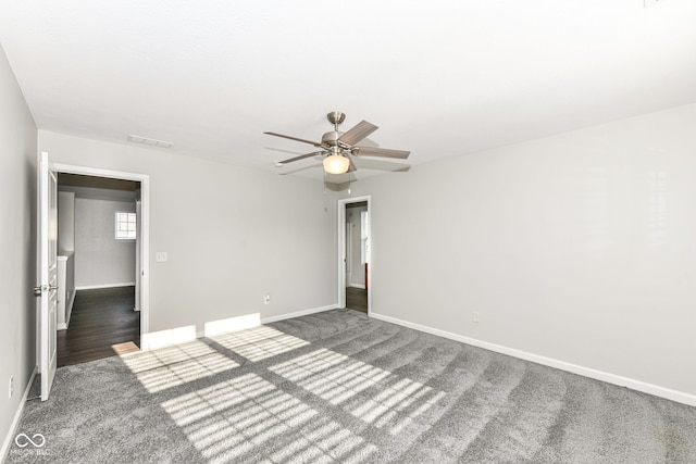 unfurnished room featuring ceiling fan and dark carpet