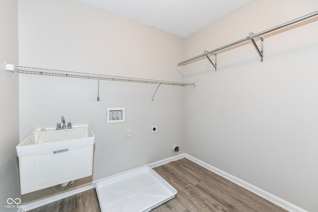 washroom with sink, wood-type flooring, washer hookup, and hookup for an electric dryer