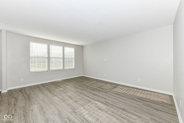 spare room featuring hardwood / wood-style floors