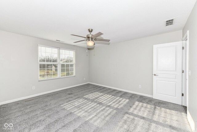 spare room featuring carpet floors and ceiling fan