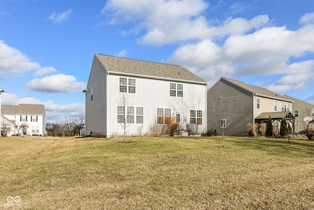 back of property featuring a lawn