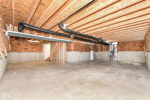 basement featuring heating unit and water heater