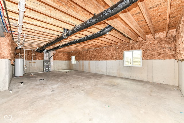 basement featuring heating unit and water heater