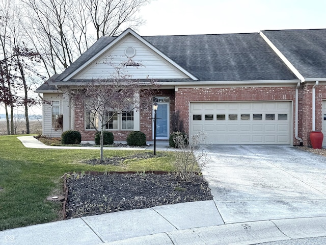 view of front of home featuring a garage and a front lawn