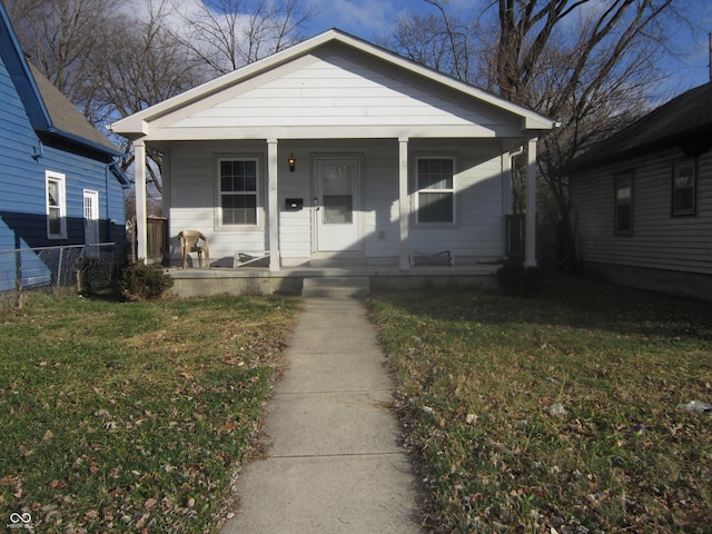 bungalow-style house featuring a front lawn and covered porch